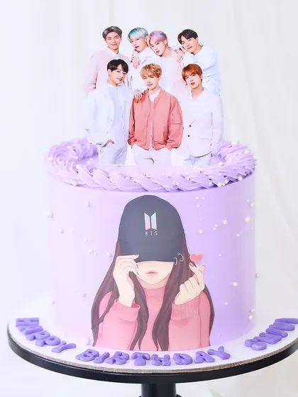 A stylish cake for a member of the BTS army. This lavender cake features an edible print of the band and a fan silhouette, finished with delicate pearl details.