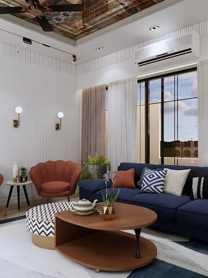 We love adding pops of color to bring a space to life. This living room features a bold blue sofa and vibrant orange accent chairs, set against a neutral background with a stunning reflective ceiling panel.
