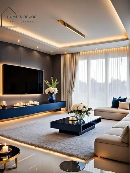 A moody and luxurious living room with a dark accent wall and integrated LED lighting. The low-profile blue media console and plush white rug add to the modern, high-end feel.