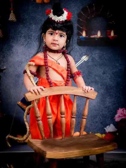 Celebrating Ram Navami with a special themed shoot. This little one is dressed as Lord Ram, complete with a bow and arrow, standing proudly in our festive studio setup.