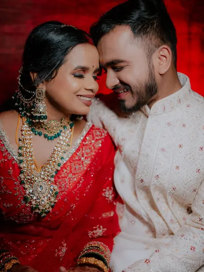 A warm and intimate portrait of the couple, with the bride showcasing her magnificent jewelry.