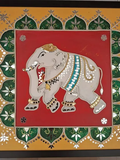 An ornate depiction of an elephant in traditional Indian style with mirror embellishments, part of the 'Aaina' exhibition.