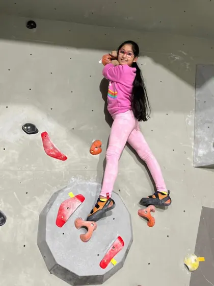 Look at that focus and joy! Our kids' classes are designed to be the ultimate fun zone. This young climber is having a blast while tackling one of our colorful routes.