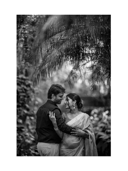 A duplicate of image 6, this black and white portrait captures the couple's serene connection amidst nature.