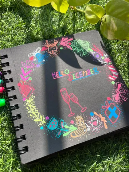 The "Hello December" doodle in the sun, surrounded by greenery.