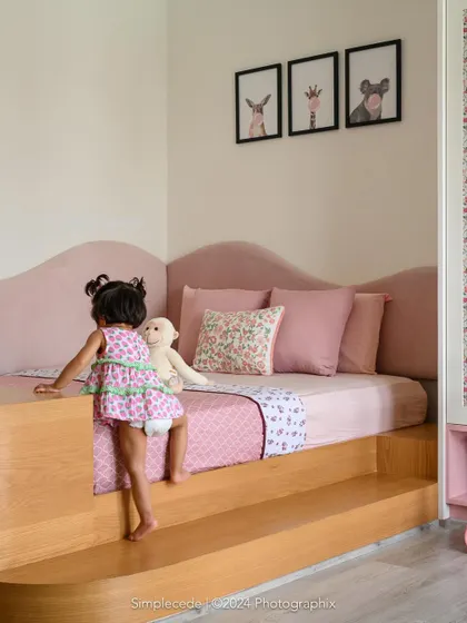 For the youngest member of the 'Cover me in Sunshine' family, we designed this blush-toned bedroom with a custom platform bed. The design is safe, accessible for a toddler, and filled with whimsical charm, proving that practical can also be beautiful.