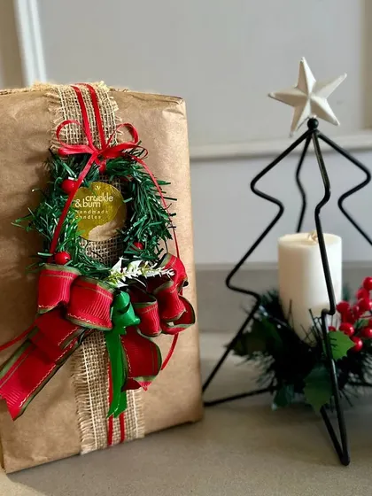 A closer look at the mini wreath gift wrapping style. I love combining textures like burlap ribbon with classic red and green to create something that feels both traditional and unique.