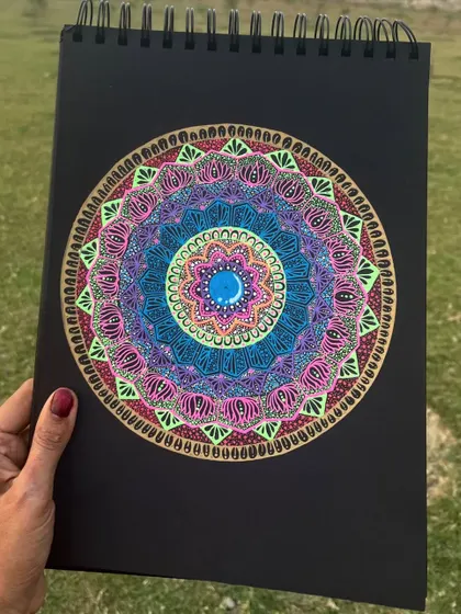 A vibrant mandala with layers of blue, pink, and lime green. This piece is perfect for anyone who loves a splash of color.