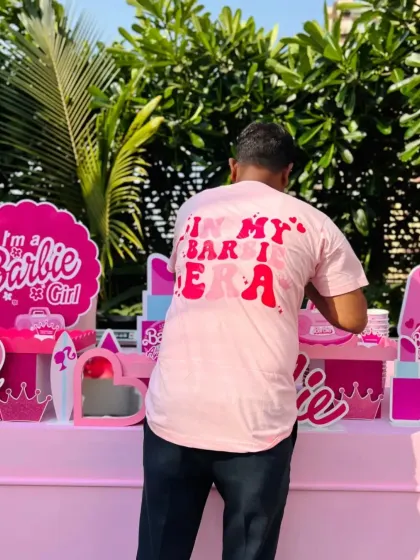 A behind-the-scenes shot of our team member setting up the vibrant pink food station.
