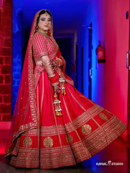 A full-length portrait of the bride, her pink lehenga beautifully contrasted against the dramatic lighting.