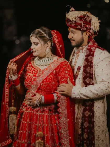 A classic wedding portrait of the couple, with the groom's arm gently around his bride, capturing a moment of quiet connection.