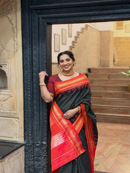 A smiling portrait of Madhurani. Her warm and friendly personality shines through, and the makeup enhances her features without being overpowering.