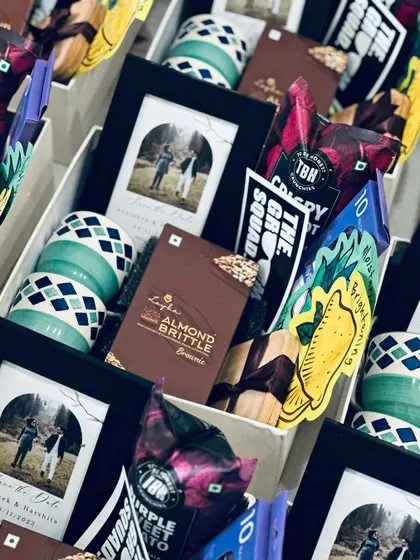 Detailed shot of a groomsman gift box. The personalized photo frame with the couple's picture is a wonderful keepsake for their friends.