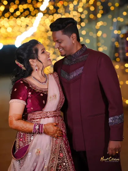 A candid shot of a couple sharing a laugh. The warm bokeh background adds to the joyful and celebratory feel of the reception.