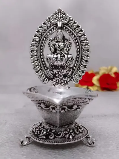 This antique German silver Lakshmi diya includes a stand for incense sticks (vathi). It's a thoughtful design that combines two pooja essentials in one beautiful piece.