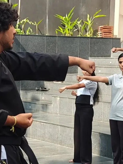 During a workshop for the students at ISBR Business School, my instructors guide participants through fundamental striking techniques. Every session involves active practice to ensure each person understands the movements correctly.