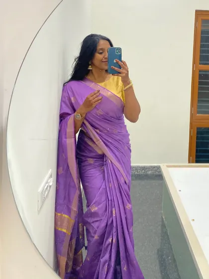 My never-ending love for sarees! This picture in a beautiful purple silk saree reflects my deep connection to traditional Indian attire, which is a huge part of our dance culture.