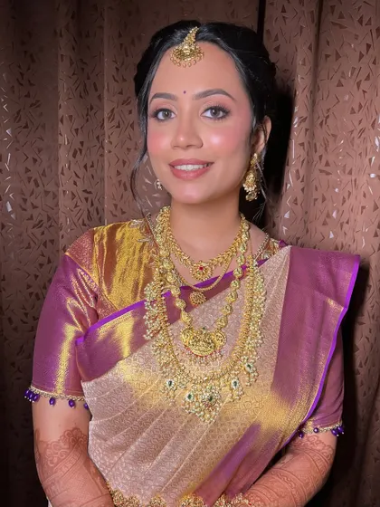 A classic portrait pose, showcasing the beautiful balance between the traditional attire and the modern, soft makeup.