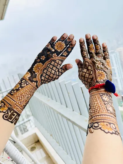 A side view of the baby shower mehendi, showing the 'Baby Shower' text on the wrist.