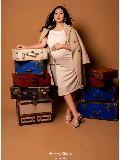 A confident and stylish pose. The neutral makeup palette works beautifully with the beige tones of the outfit.