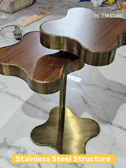 Would you like this for your cup of coffee? This unique, two-tiered coffee table features a clover-shaped design with a stainless steel structure in an antique brass finish and rich walnut wood tops.