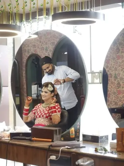 A behind-the-scenes shot of the bride getting her hair done at the salon. This photo captures the final stages of her transformation and the anticipation of the moments to come.