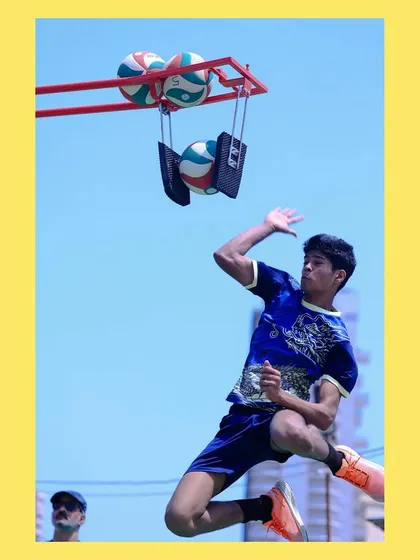 A dynamic shot of a player jumping to spike a ball held by our training equipment. This allows for hundreds of repetitions to perfect form.