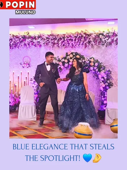 This couple is stealing the spotlight. He is in a classic black tuxedo, and she is in a stunning blue gown, creating a dramatic and elegant look for their reception.