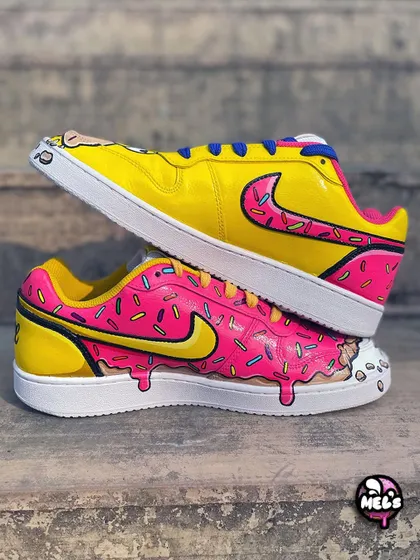 A stacked shot of the Homer and donut themed Nike sneakers, showing how the two complementary designs create one awesome pair.