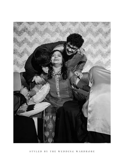 A candid moment from the Mehendi, where the bride's brothers shower her with affection.