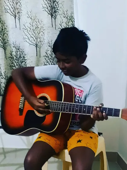 "If music be the food of love, play on." This student is completely absorbed in his practice, a moment of pure musical connection.