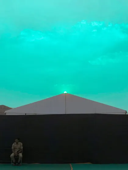 A surreal, color-shifted version of the sunset scene, with the sky turned a bright, unnatural turquoise.