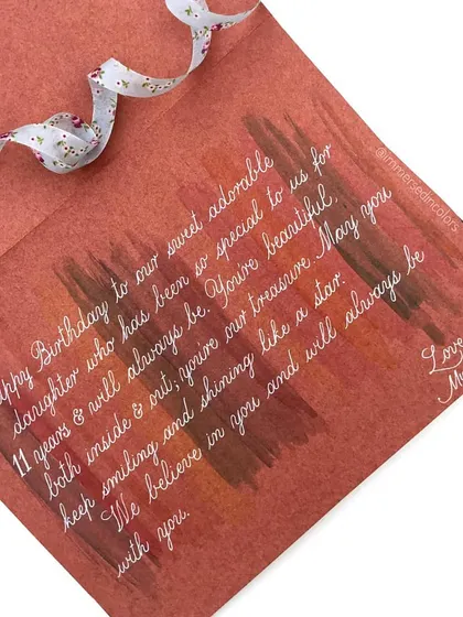 The inside of the rainbow birthday card, with a personal message from the parents. The background is a soft wash of gouache colors to complement the front.