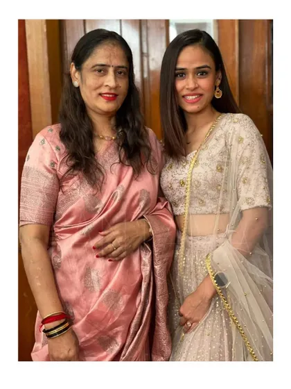 Another view of the mother and daughter in their custom Tantava outfits, showcasing the intricate silver embroidery on the lehenga and the elegant simplicity of the saree blouse.