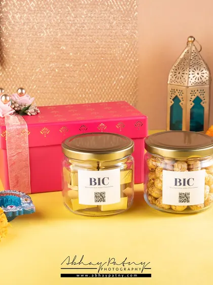 This festive shot for a gifting brand uses color and props like diyas and marigolds to create a celebratory mood. The focus remains on the product jars, showing them as a perfect gift for the occasion.