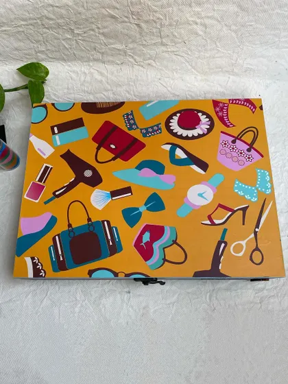 A flat lay of the decoupage lid, showing the variety of fun illustrations in the fashion-themed design.