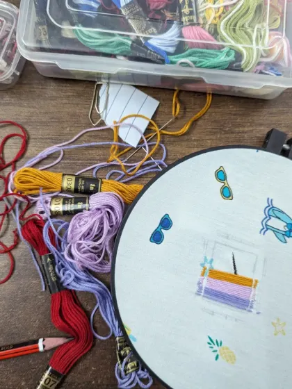 A close up of a visible mending project in progress. We provide all the colorful threads and materials you need.