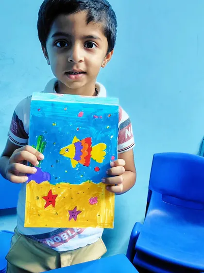 This student created a beautiful underwater scene with a colorful fish and starfish on the ocean floor.