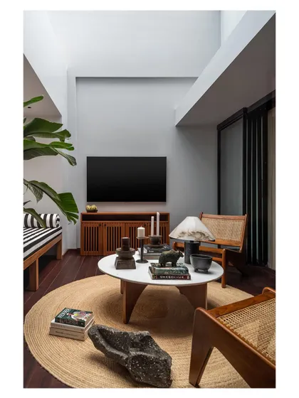 A full view of the master bedroom lounge, showcasing the double-height volume and the careful arrangement of furniture. This is a prime example of creating a luxurious private retreat within a larger home.