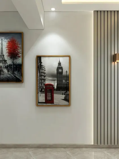 This foyer doubles as a mini art gallery, with framed pictures of Paris and London set against a clean wall with modern sconces and fluted paneling.