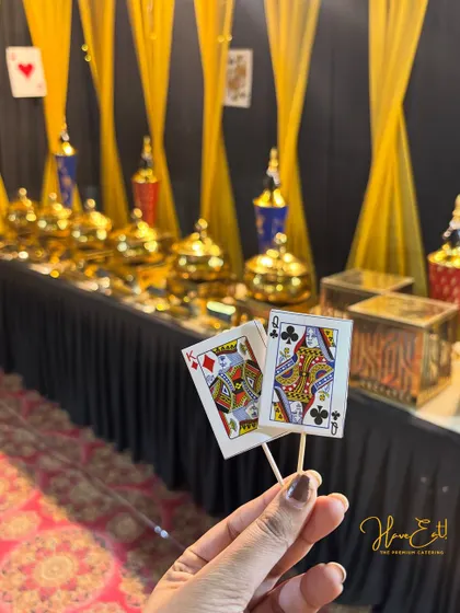A close-up of the card-themed food toppers used for our Diwali party catering, showing our attention to the smallest details.