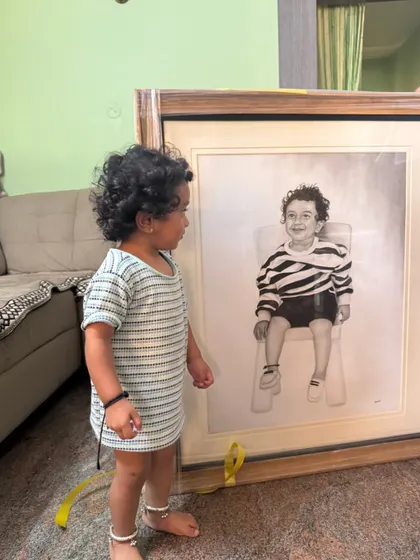 A candid moment of a toddler curiously looking at his own portrait. Capturing the innocence of childhood is one of my favorite things to do.