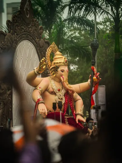 The Chinchpoklicha Chintamani idol making its way through the crowded streets. I shot this from within the crowd to give a sense of the massive scale and the public's excitement.