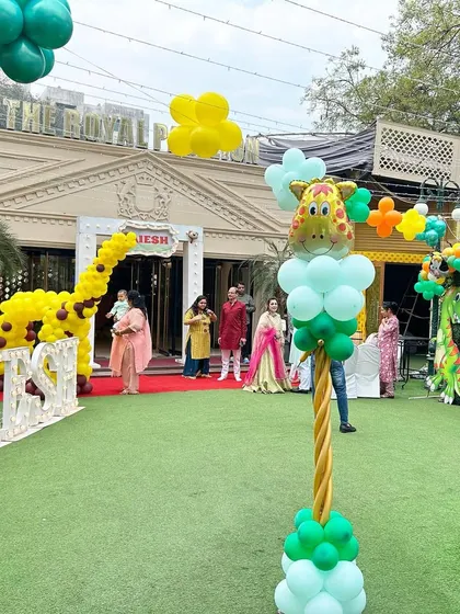 An outdoor event space showing the decorated entrance and marquee letters on the lawn. We can transform large outdoor areas for any celebration.