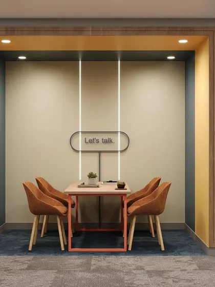 A sneak peek render of a semi-private meeting nook. The "Let's talk" sign and comfortable seating create an inviting space for focused conversations within an open-plan office.