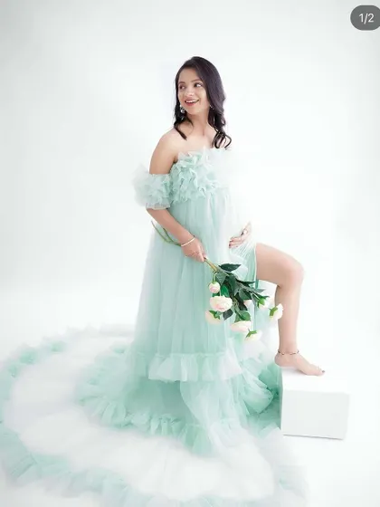 A duplicate of image 69, this playful portrait shows a mom-to-be in a flowing mint green gown, her pose full of joy and energy.