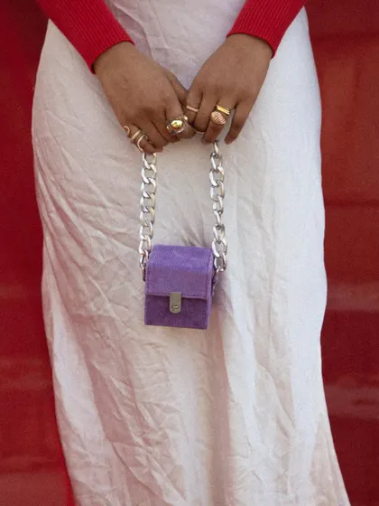 A detail shot of the miniature purple bag with its chunky silver chain.