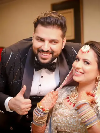 A fun and candid moment between a brother and his sister, the bride. His thumbs-up and their shared smiles make for a happy and memorable photo.