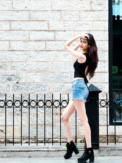 A wide shot showing the model interacting with the urban environment. This helps to create a story and a sense of place.