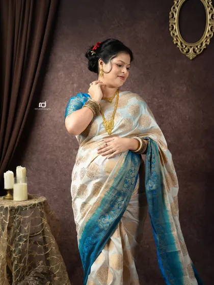 An elegant pose in a traditional silk saree. This solo portrait highlights the beauty of the fabric and the grace of the mom-to-be.